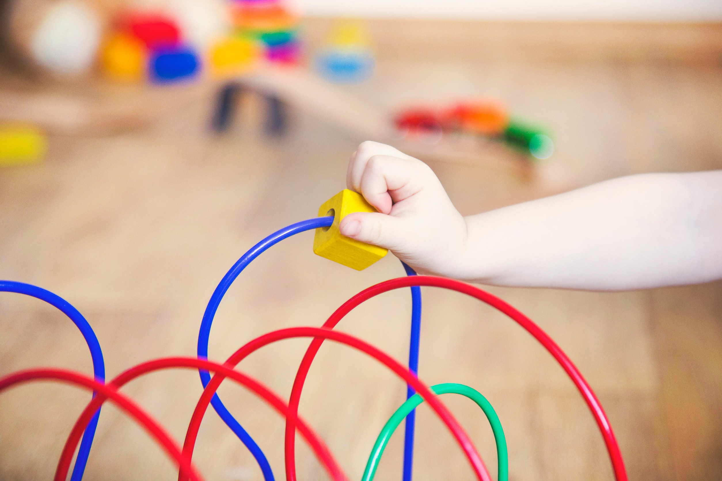 The hands of a child girl playing toys. development of fine motor skills